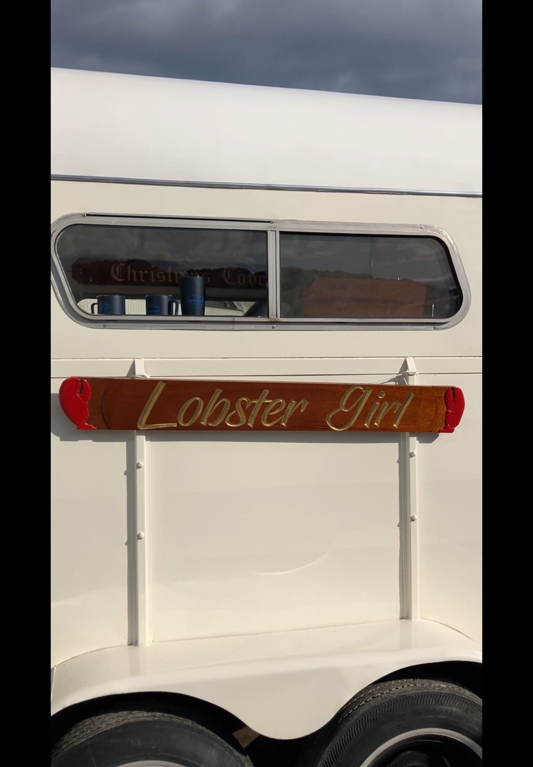 Lobster Girl wooden sign mounted on the trailer